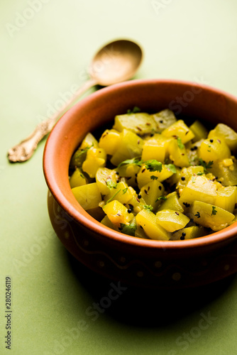 Lauki/doodhi ki sookhi Sabji also known as bottle gourd dry vegetable recipe. served in a bowl or karahi. selective focus photo