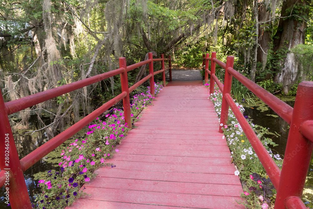 The red bridge in Magnolia plantation and garden near Charleston, South Carolina The red bridge in Magnolia plantation and garden near Charleston, South Carolina