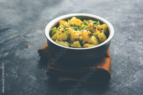 Lauki/doodhi ki sookhi Sabji also known as bottle gourd dry vegetable recipe. served in a bowl or karahi. selective focus photo