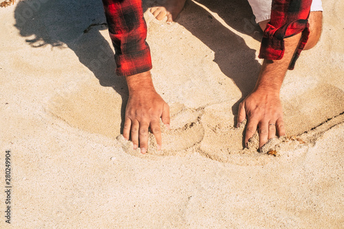 Sand beach and men hands touching and moving enjoying the summer - concept of holiday vacation and traveler people - enjoying outdoor leisure activity at the sea side