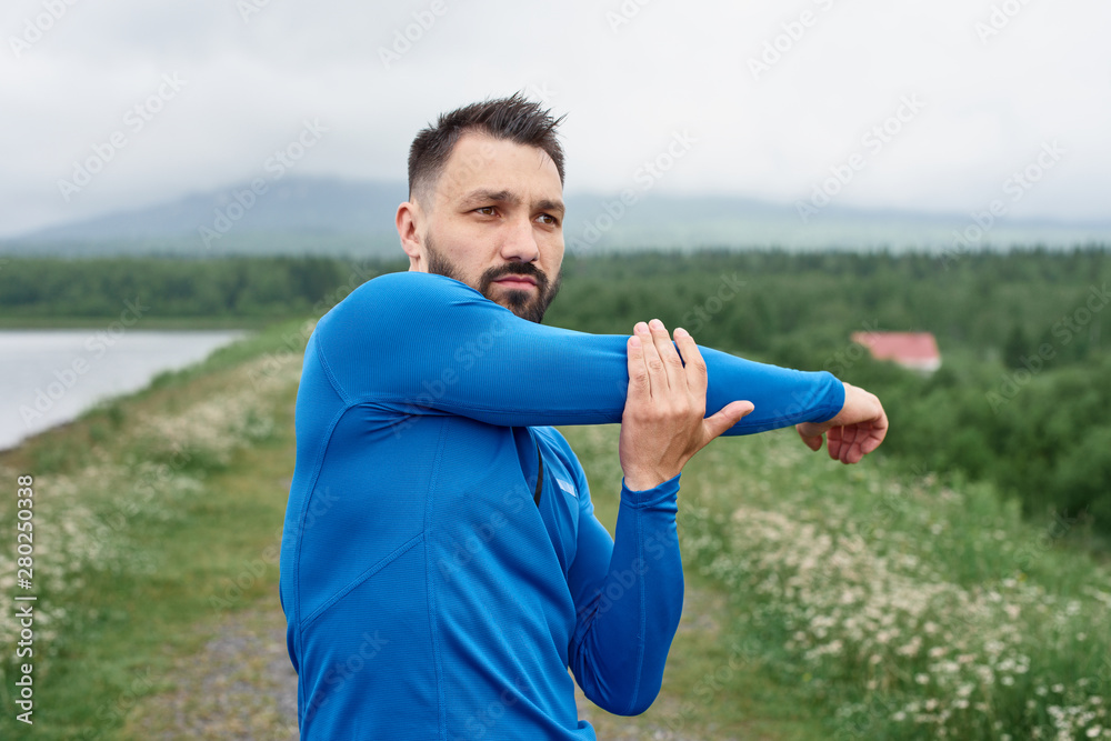 Man exercising outdoor on gloomy day Man exercising outdoor on gloomy day