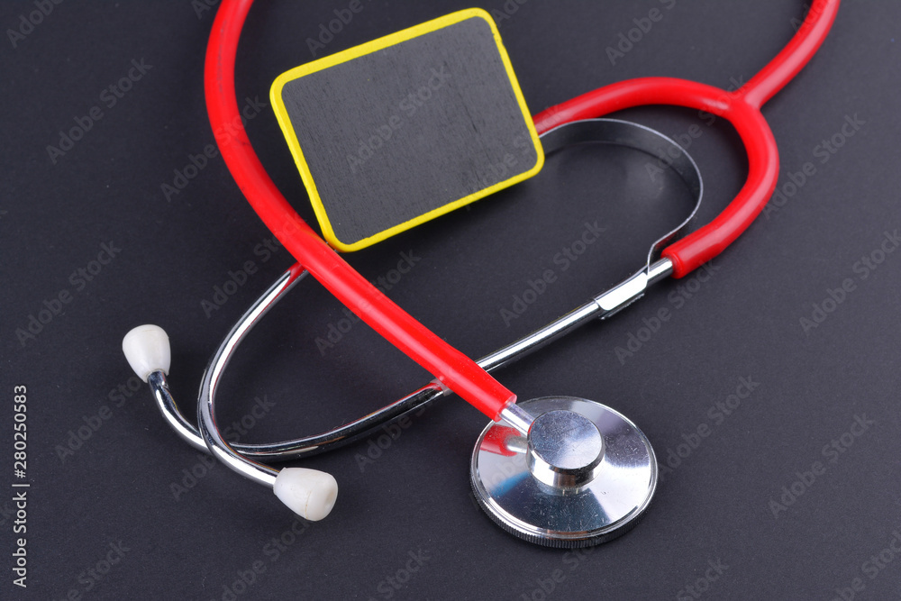 Stethoscope on black background with text. MEDICAL CONCEPT Stethoscope on black background with text. MEDICAL CONCEPT
