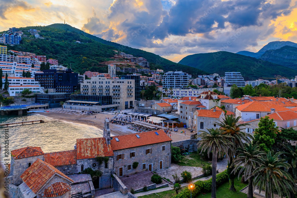 Budva Old Town aerial view from the Citadel with Adriatic Sea and Richard s Head beach at sunset in Montenegro, Balkans