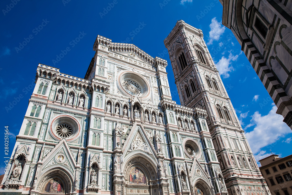 The Giotto Campanile and Florence Cathedral consecrated in 1436 against a beautiful blue sky