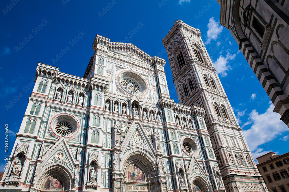 Fototapeta premium The Giotto Campanile and Florence Cathedral consecrated in 1436 against a beautiful blue sky