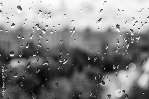 Drops of rain on the glass. Black and white summer photo