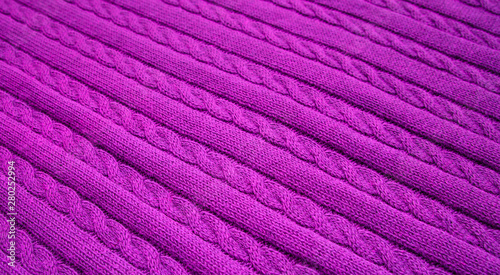 Texture of knitted dark purple fabric. Violet knitted abstract background.