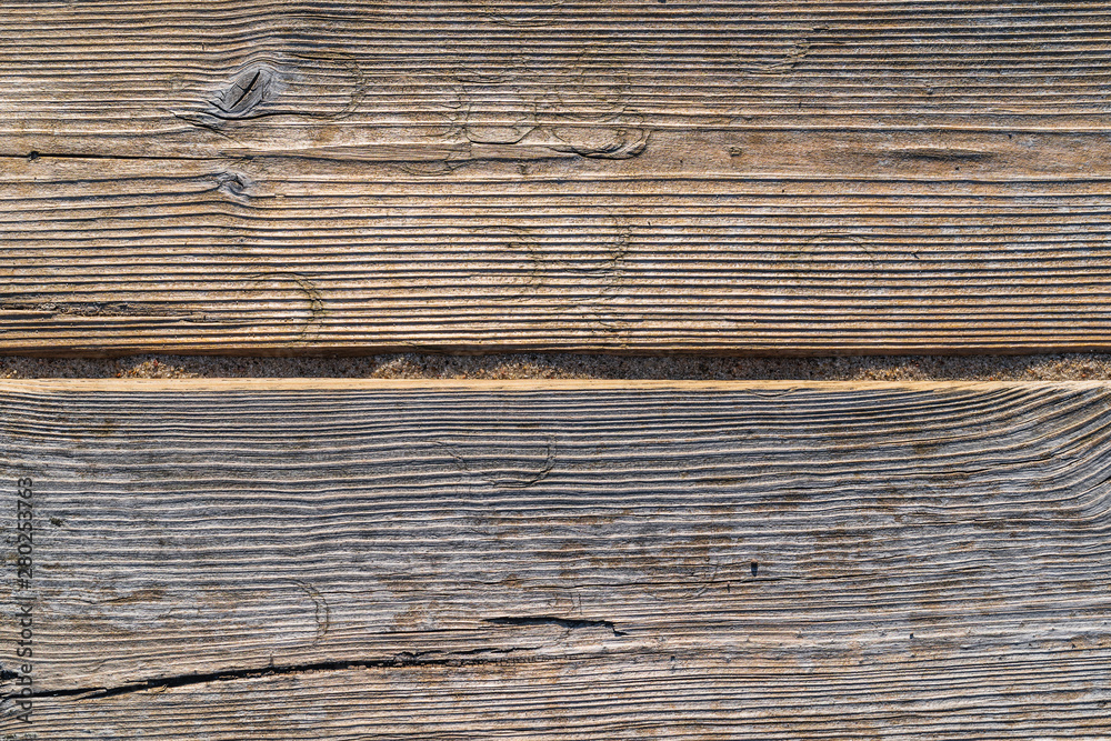 Worn old boards lie in the sun on the beach, background, texture Worn old boards lie in the sun on the beach, background, texture