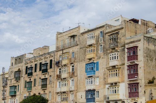 Facade of the house with blue and green maltese balconies in Valletta in Malta