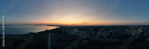 Aerial panoramic view of a to the coastline of the city with dramatic clouds sunset sky and views of the sea surface. Beautiful view of the sea and sunset. Postcard view. Nature