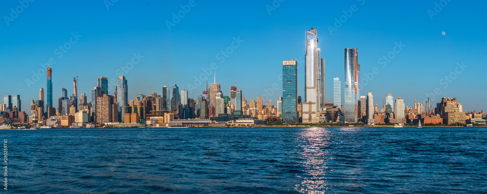 View to Manhattan skyline from Weehawken Waterfront in  Hudson River at sunset.