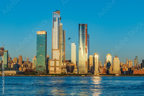 View to Manhattan skyline from Weehawken Waterfront in Hudson River at sunset.