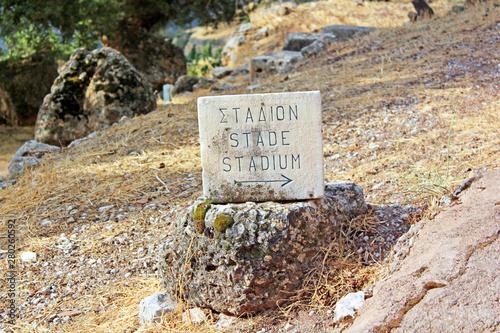 Pointer of ruins of stage theater in Delphi, Greece