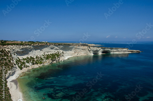 Munxar path. White rocks with blue water in Malta near Marsaxlokk, Saint Peter Pool.