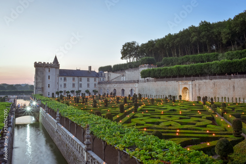 VILLANDRY CASTLE, FRANCE - JULY 07, 2017: The garden illuminated by 2,000 candles at dusk . Nights of a Thousand Lights at Villandry castle, France on July 07, 2017 photo