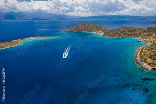 Aerial drone view of the dry summer coastline and crystal clear waters of the Greek island of Crete