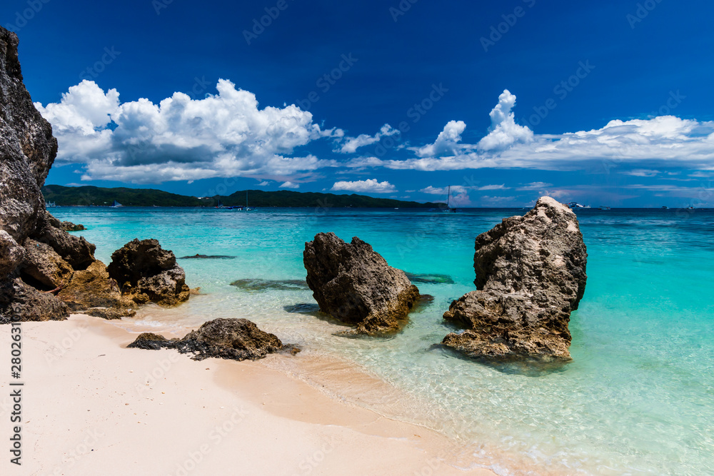 A beautiful tropical sandy beach and shallow, clear ocean (White Beach, Boracay) A beautiful tropical sandy beach and shallow, clear ocean (White Beach, Boracay)