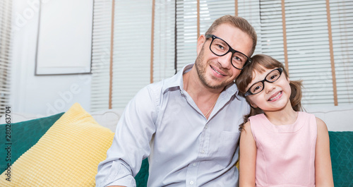 Portrait of nerd caucasian father daughter wearing glasses smiling. Nerdy daddy and little girl spending time at home . Fun love happy family lifestyle single dad love fatherâ€™s day concept © paulaphoto