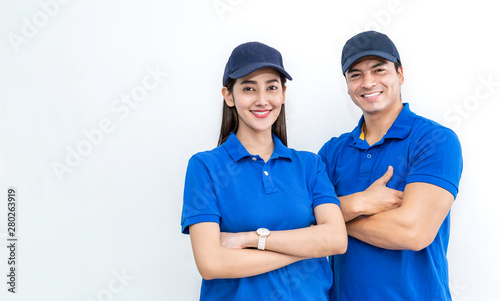 Portrait of smart happy delivery couple man woman isolated on white background, Young asian team wearing blue uniform. Delivery business teamwork concept photo