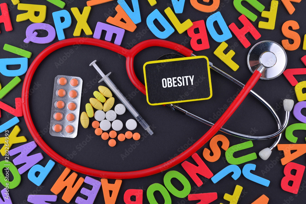Pills, Syringe and Stethoscope with alphabet and text Obesity