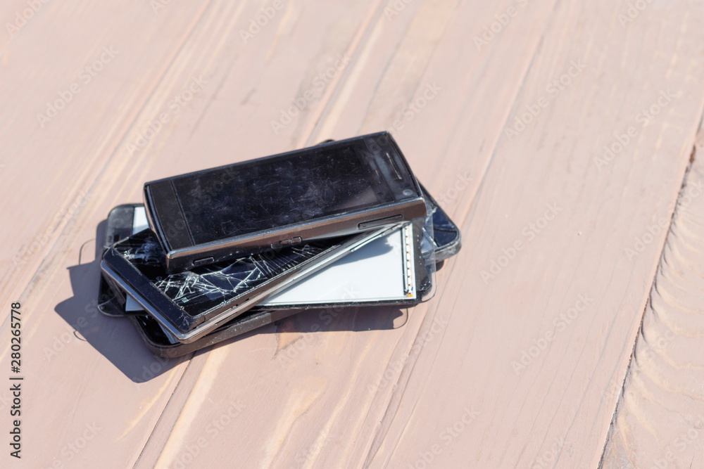 daylight. broken mobile phone. wooden background. have toning