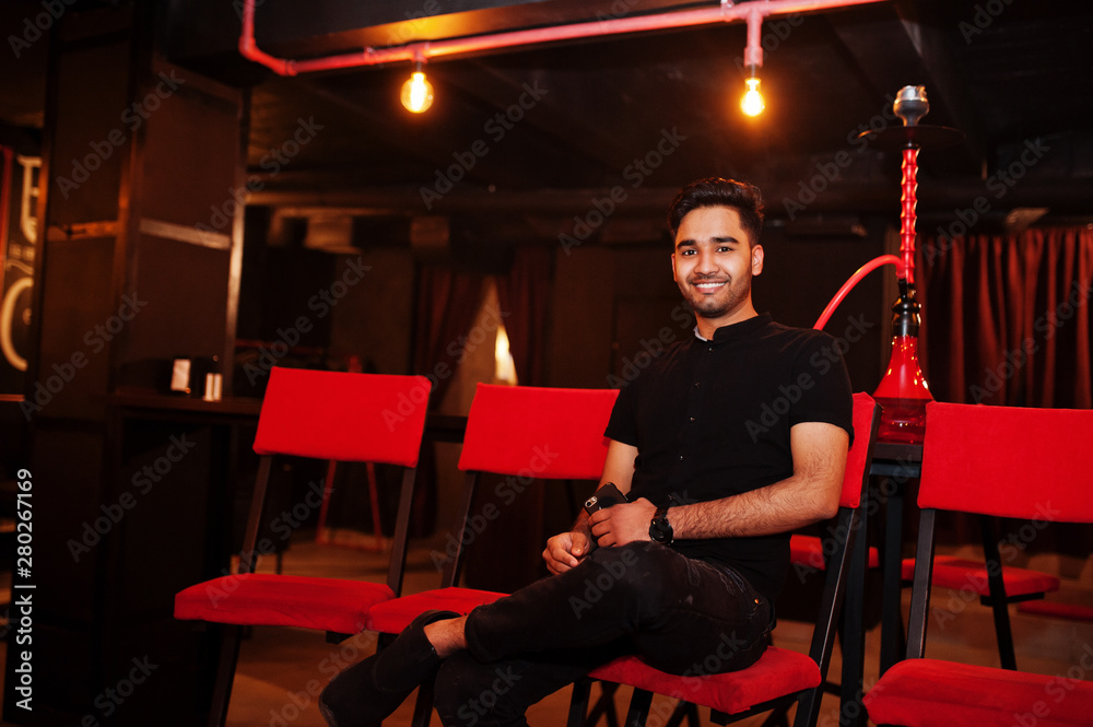 Asian man smoke hookah and having rest at lounge bar. Asian man smoke hookah and having rest at lounge bar.