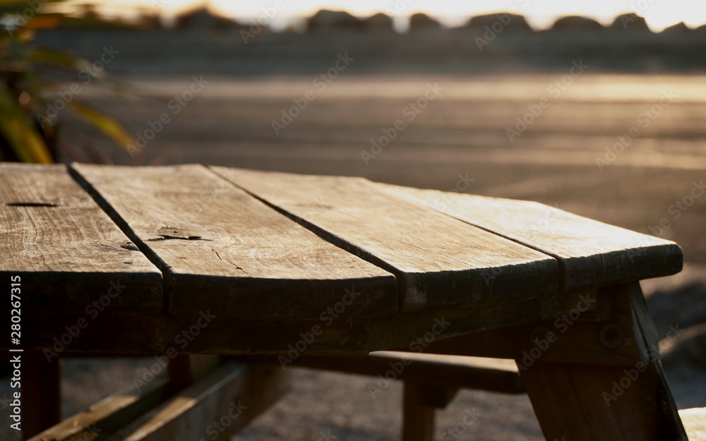 Wooden table during sunset on the beach Wooden table during sunset on the beach