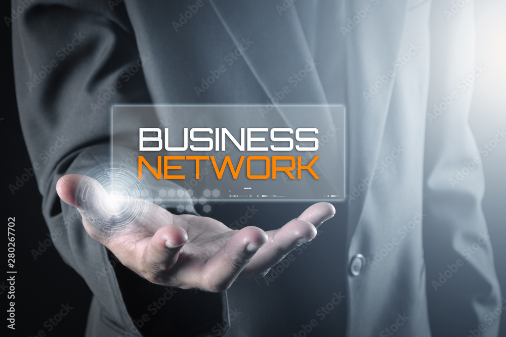 Hand holding transparent screen with text BUSINESS NETWORK Hand holding transparent screen with text BUSINESS NETWORK