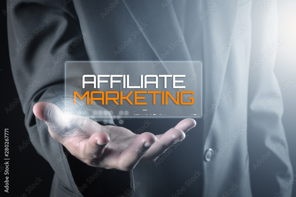 Hand holding transparent screen with text AFFILIATE MARKETING Hand holding transparent screen with text AFFILIATE MARKETING