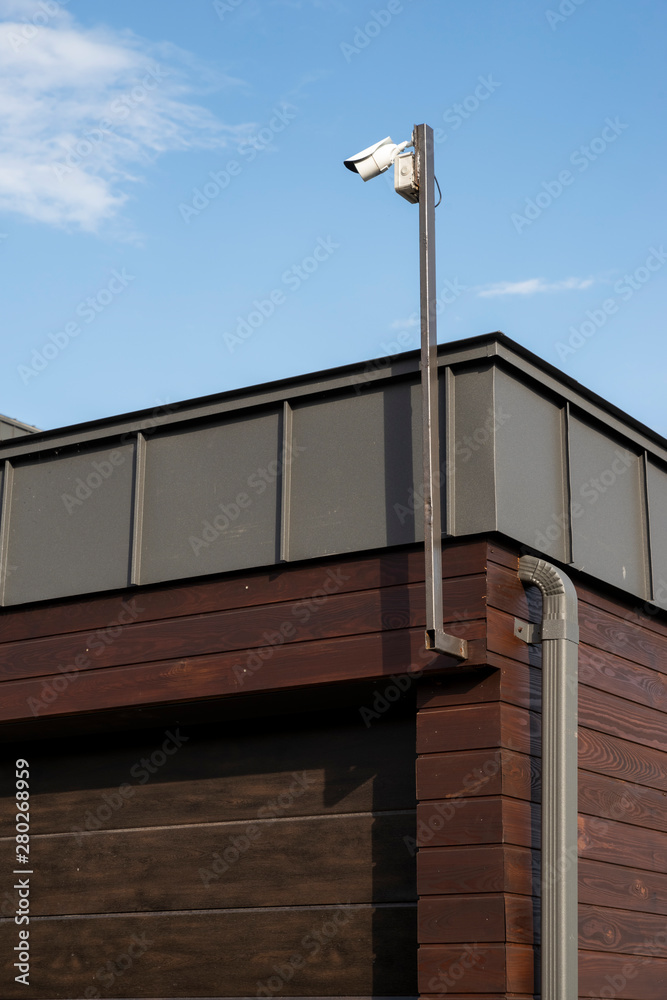 video surveillance camera on a pillar on a garage building video surveillance camera on a pillar on a garage building