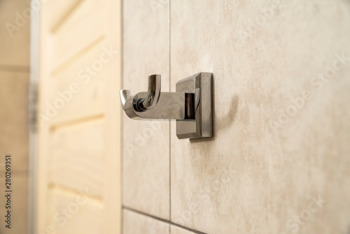 Chrome wall mounted hook for two towels © Andrey