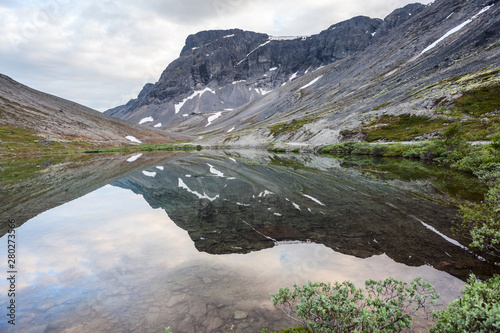 Calm surface of mountain lake with reflection, Khibins mountains in Kola Peninsula, Russia