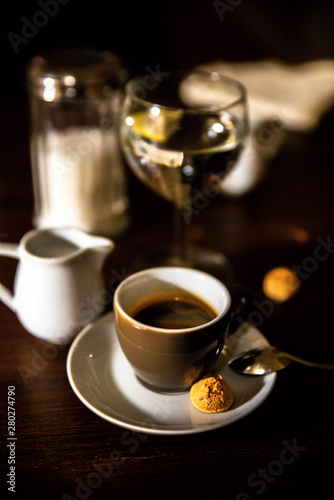 Cup of coffee, wine, milk and sugar on dark background.