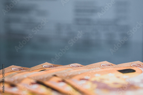 Stack of Euro banknotes (€) - Closeup on 50 EURO banknots. Blurred invoice in background. Best for tax, financial topics