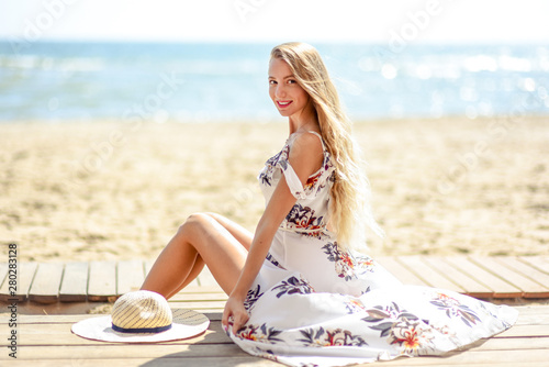 Nice women with flowers on the beach feals happy photo