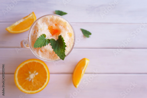 orange smoothie, milkshake with orange and mint photo