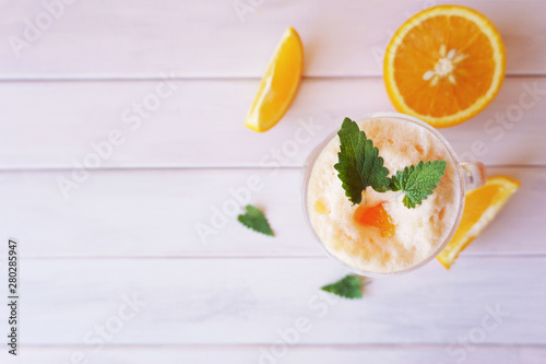 orange smoothie, milkshake with orange and mint photo