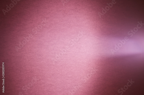 A light purple ray of light cuts through a deep pink textural cloud of light
