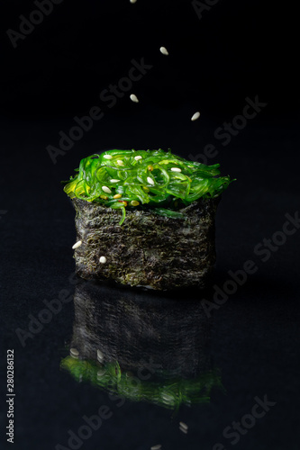 seaweed sashimi with levitating sesame  photo