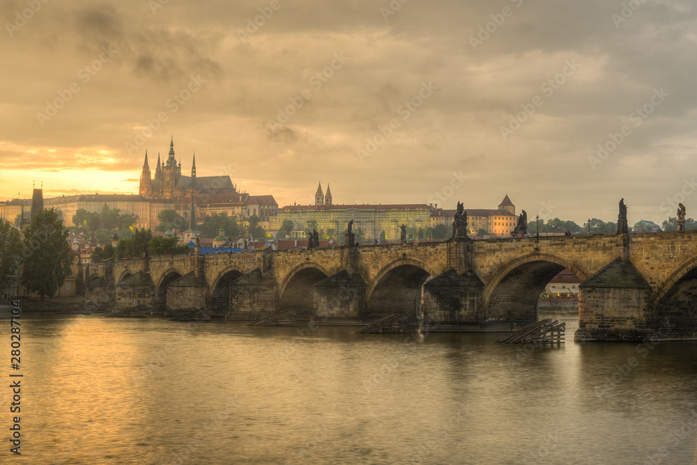  View of Charles Bridge, Prague Castle and Vltava river in Prague, Czech Republic during  sunset