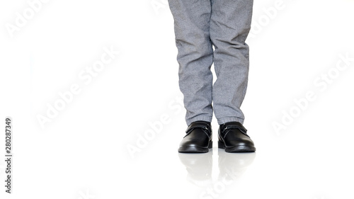 closeup of boy's legs in black classic shoes for boys
