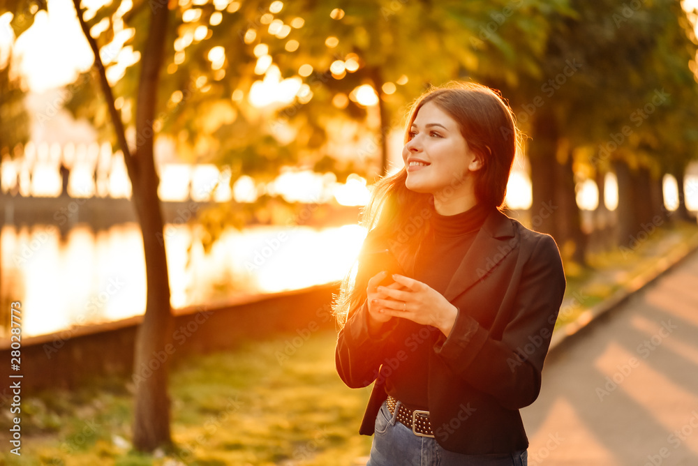 Happy girl using a smart phone in a city park. Happy girl using a smart phone in a city park.