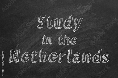 Hand drawing "Study in the Netherlands" on black chalkboard.