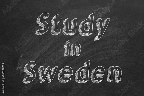 Hand drawing "Study in Sweden" on black chalkboard. 