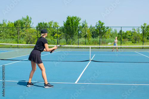 Young sports women playing tennis on the blue tennis court © Dmytro Flisak