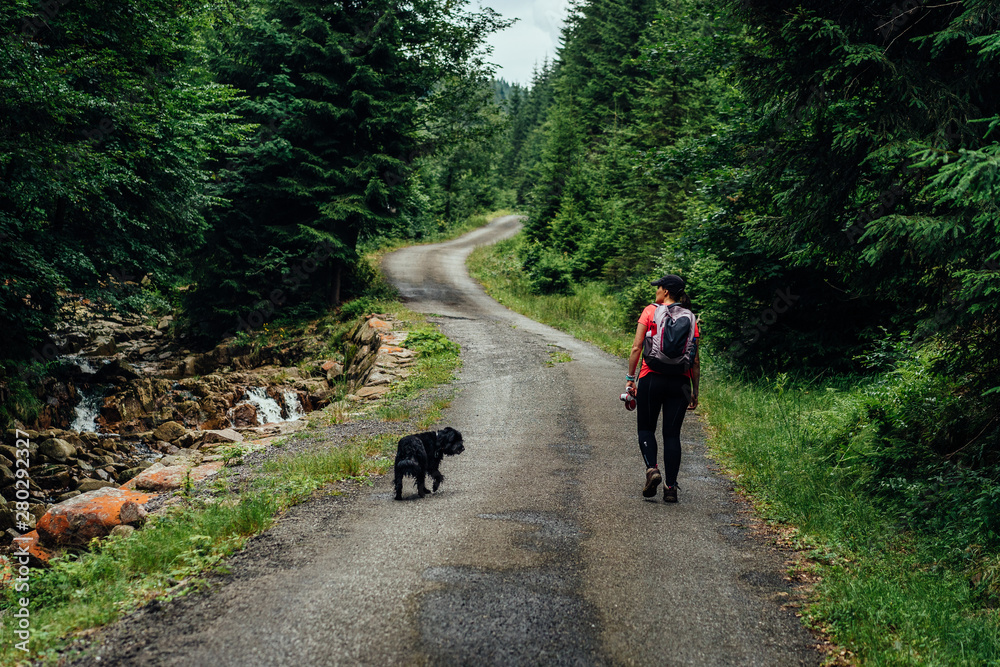 Young woman on the trail in Giant Mountains (Karkonosze), authentic travel experience. 