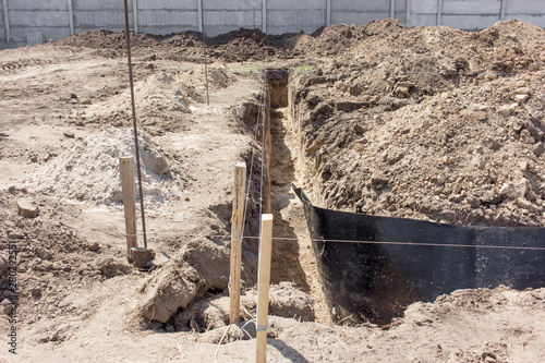 trench with pubble and formwork, which is prepared for pouring the foundation, ruberoid photo