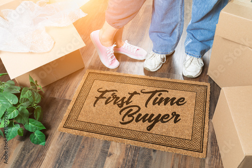 Man and Woman Unpacking Near Our First Time Buyer Welcome Mat, Moving Boxes and Plant