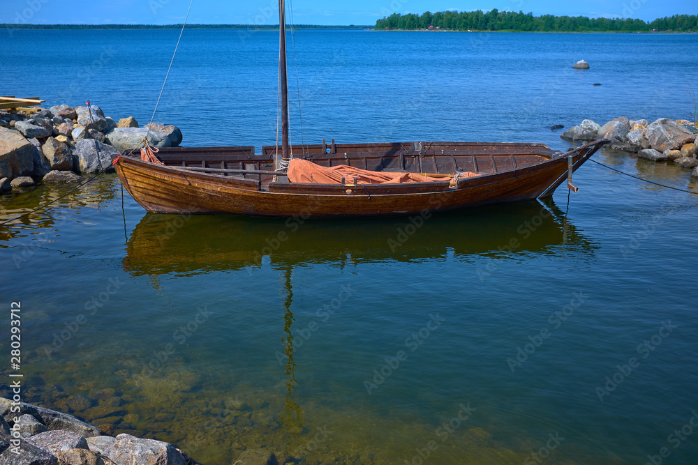 wooden boat during sunny day with reflections wooden boat during sunny day with reflections