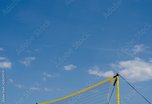 Close-up of  yellow   net filet beach volley ball  against blue sky .
